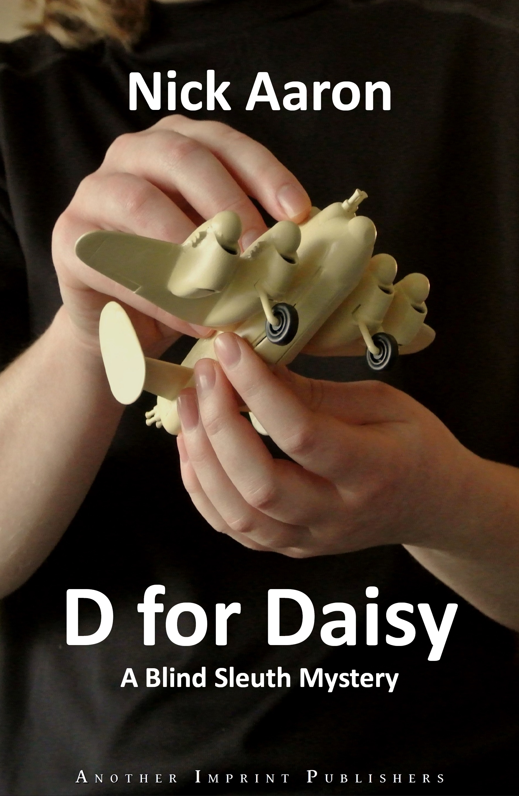 Book cover D for Daisy: female hands holding a toy airplane